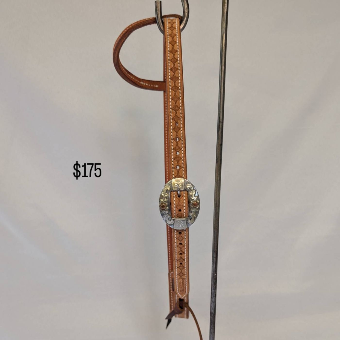 Tan diamond-stamped headstall with engraved silver buckle, number 1