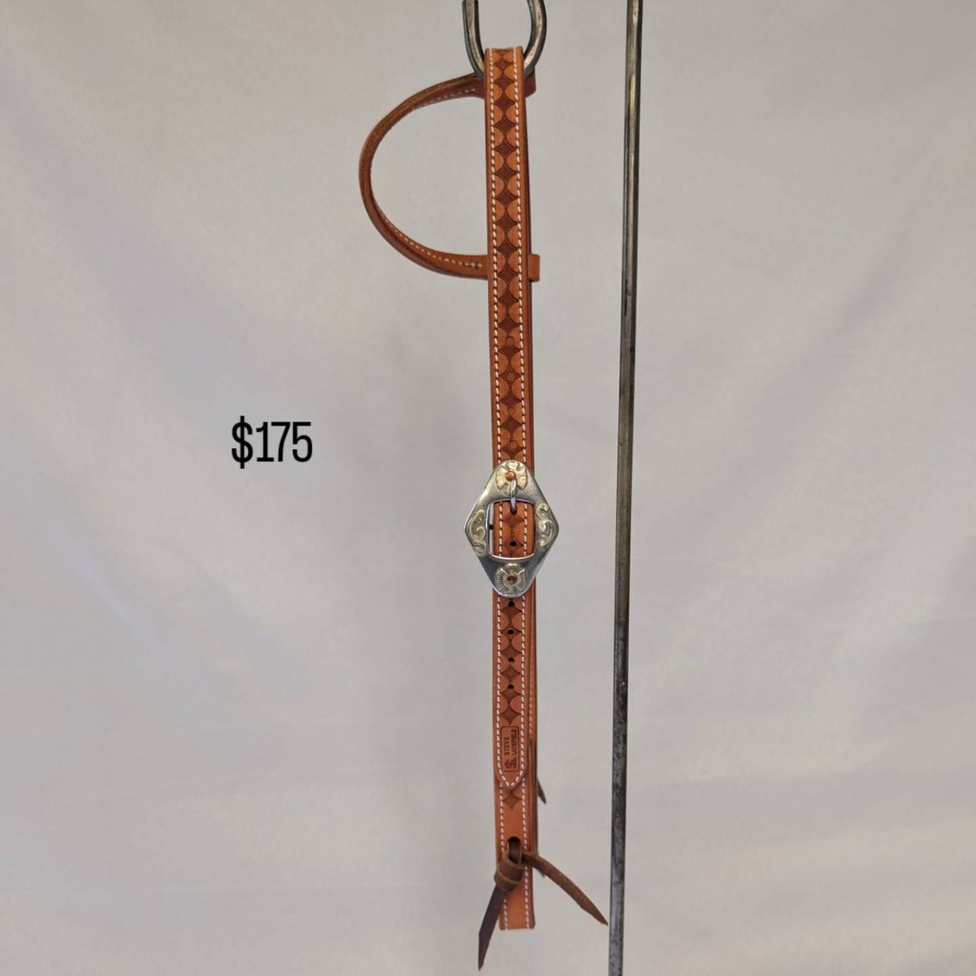 Tan diamond-stamped headstall with engraved silver buckle, number 2