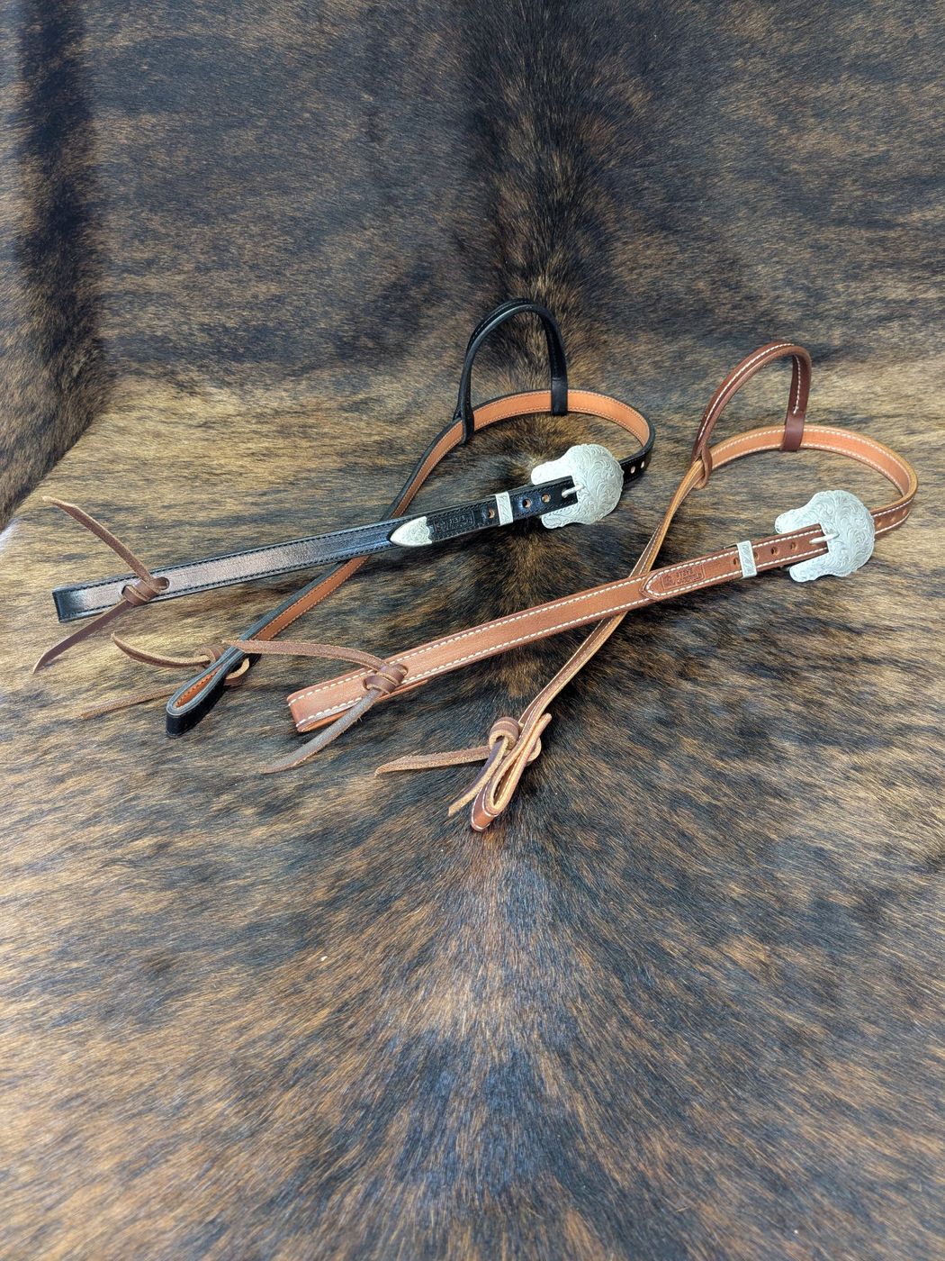 Black and brown headstalls with engraved silver buckles