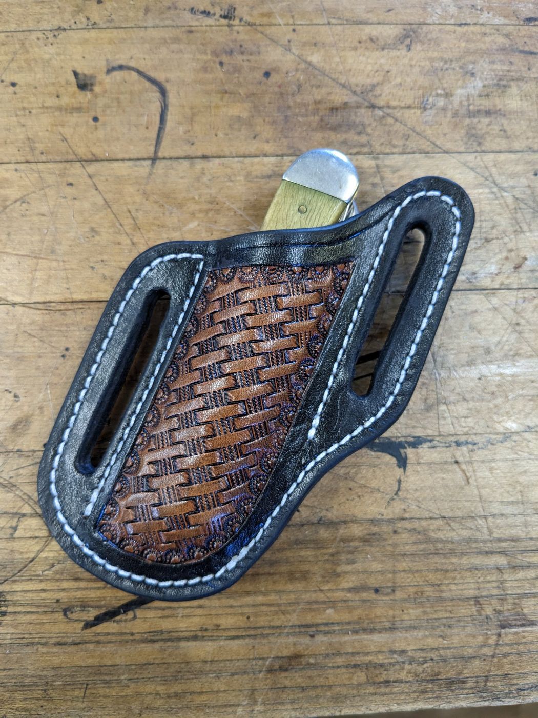 Black leather knife sheath with basket-stamp panel
