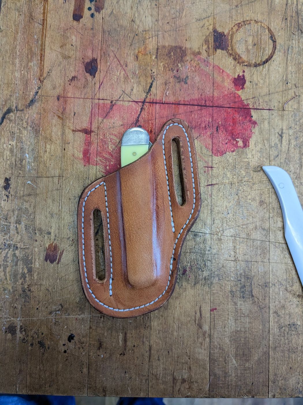 Brown leather knife sheath with pocket knife