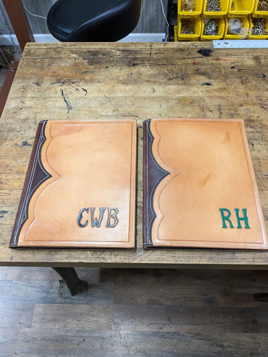 Two tooled leather padfolios with painted initials